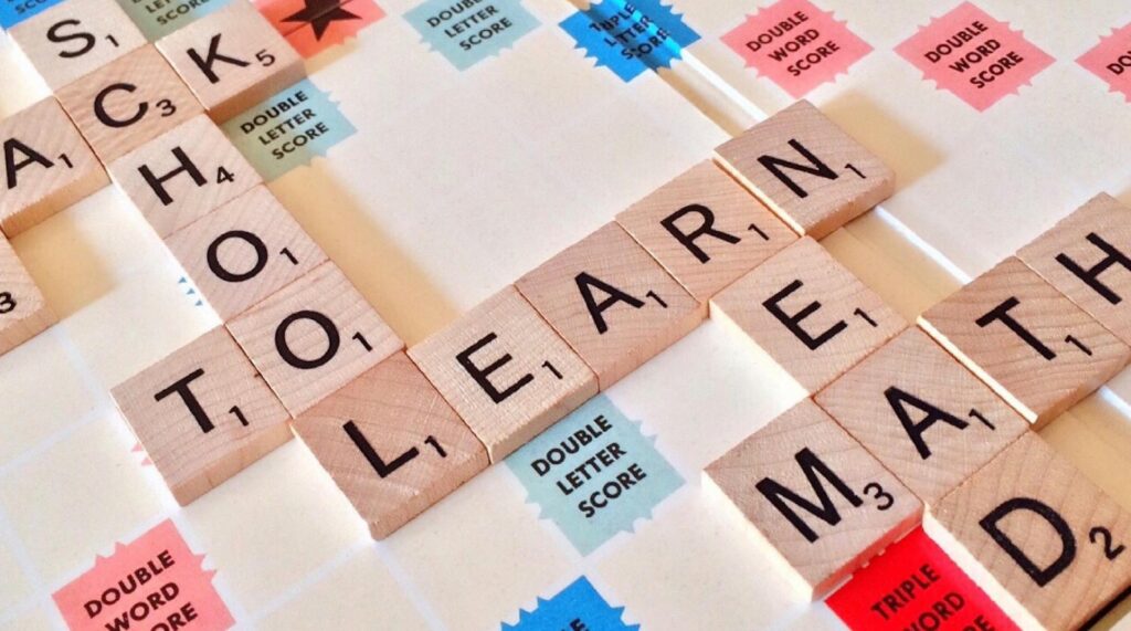 Scrabble board containing the words "school," "learn," "read," and "math."